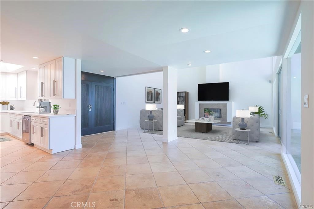 13425 Java Drive Beverly Hills, CA 90210 - Photo 26 of 28 a large white kitchen with stainless steel appliances kitchen island granite countertop a sink and cabinets