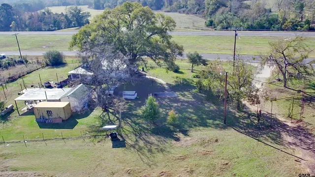 an aerial view of a house with a lake view