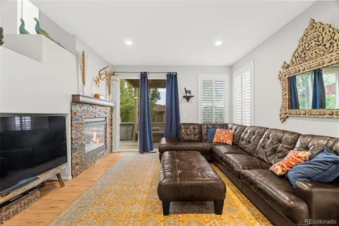 a living room with furniture tv and a flat screen tv