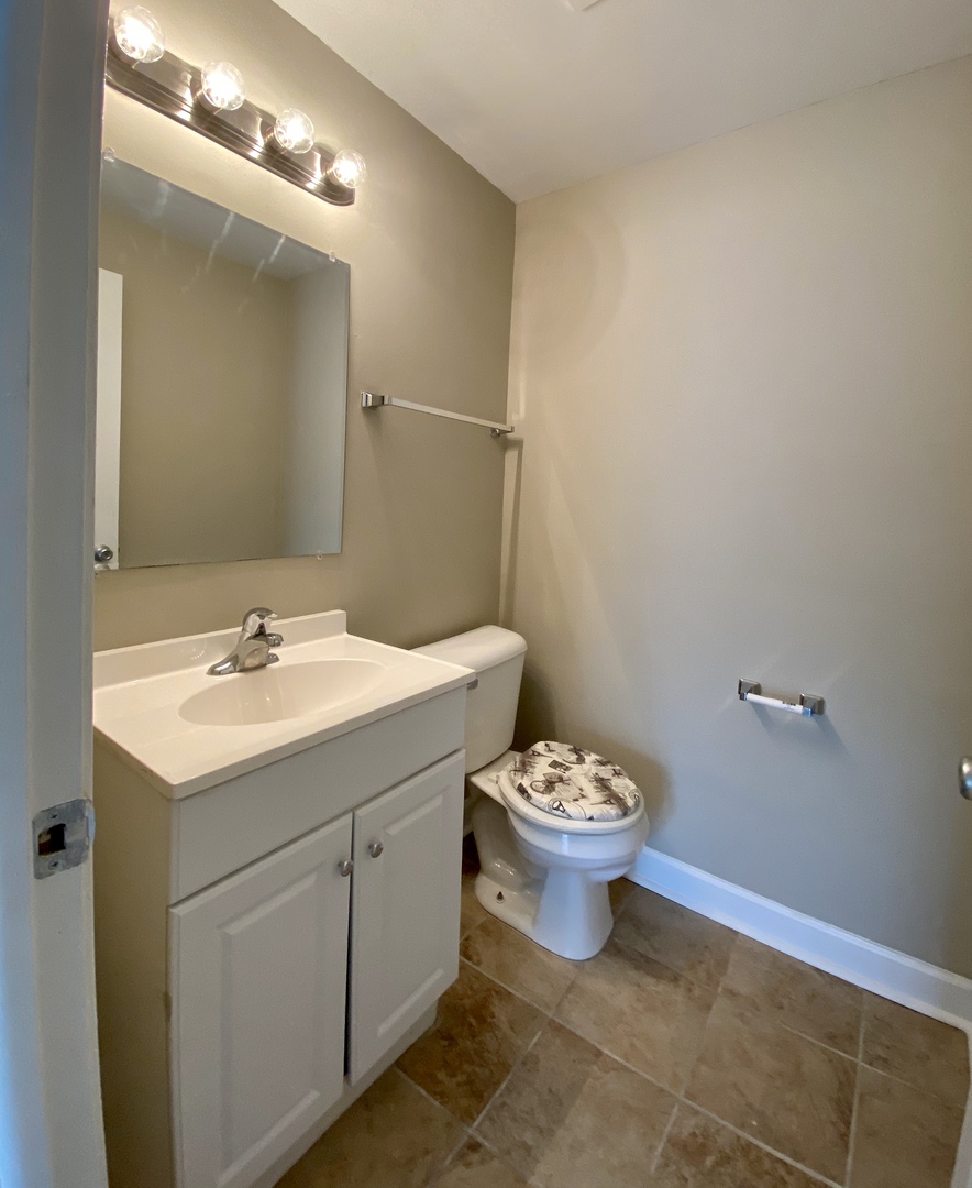 231 Oakhurst Road Matteson, IL 60443 - Photo 7 of 8 a bathroom with a toilet sink and mirror