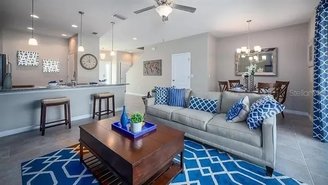 a bedroom with a balcony a bed and a chandelier