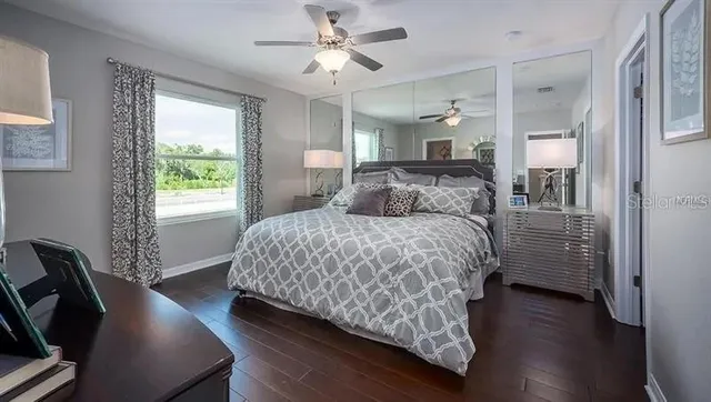a bathroom with a granite countertop sink a toilet and a mirror