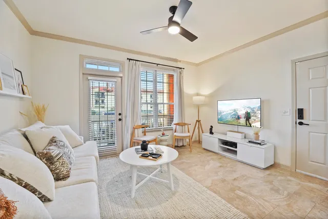 a living room with furniture and a large window