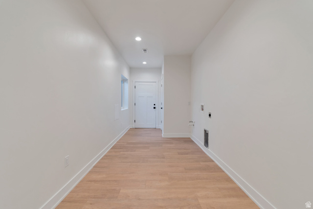 1820 West Farmhouse Flats Road Peoa, UT 84061 - Photo 36 of 79 Long hallway featuring wood-finish flooring, white walls, recessed lighting, and a white paneled door