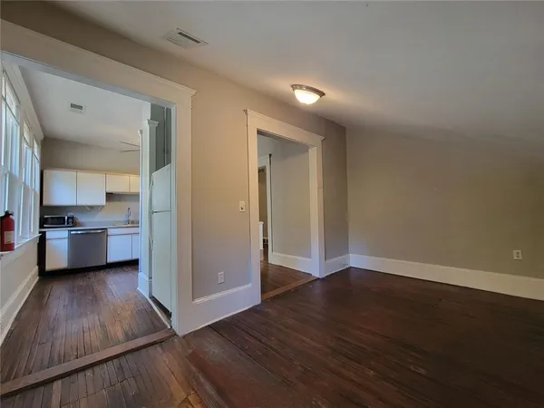 a view of a kitchen with wooden floor and a sink