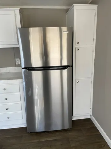 a view of a refrigerator in kitchen with a refrigerator
