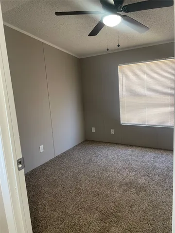 a view of an empty room and a window