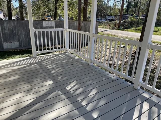 a view of a balcony with wooden floor