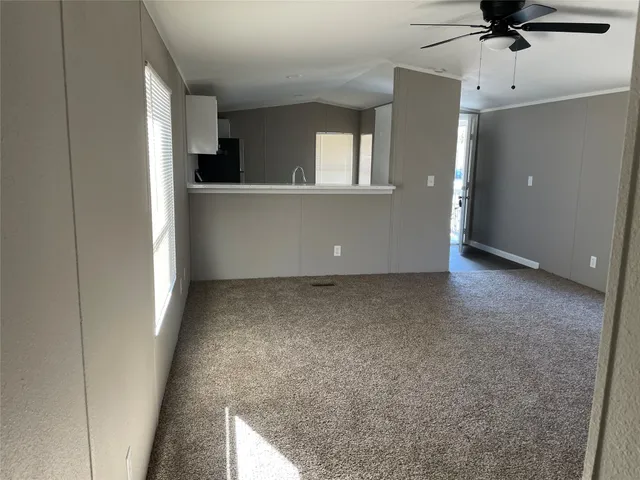 a view of an empty room with a kitchen