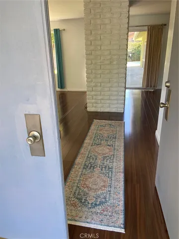 a large white kitchen with wooden floor