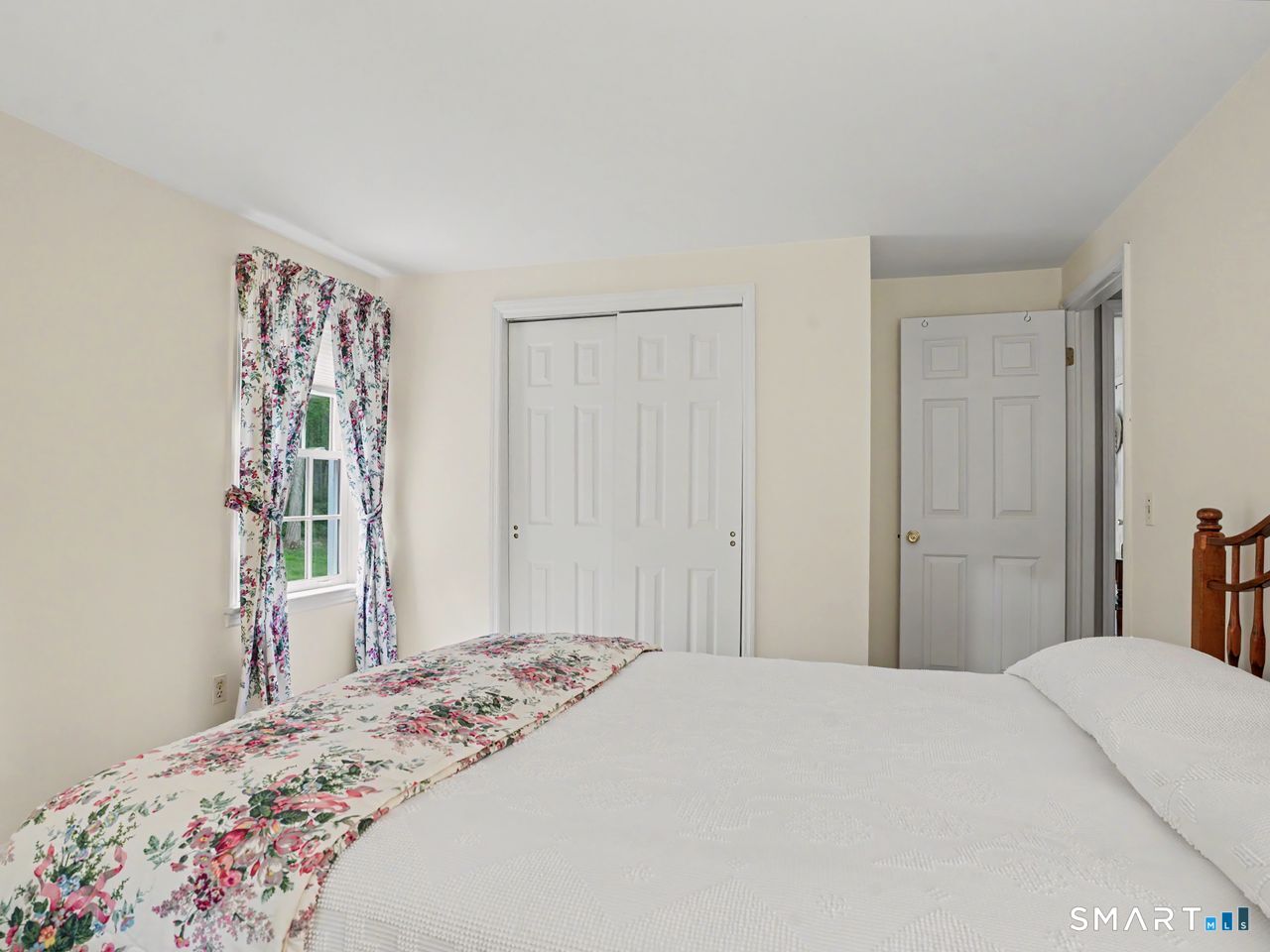 86 Fire Hill Road Redding, CT 06896 - Photo 27 of 36 a bedroom with a bed and a window
