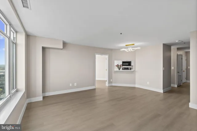 a bedroom with a large bed and a painting on the wall