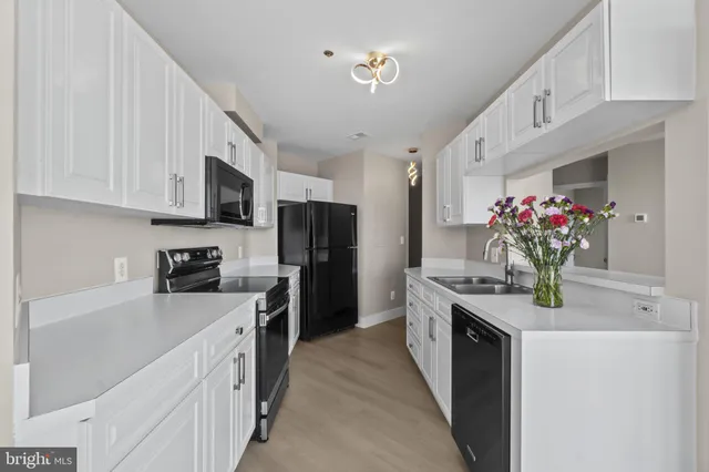 a bathroom with a bathtub shower sink vanity and mirror
