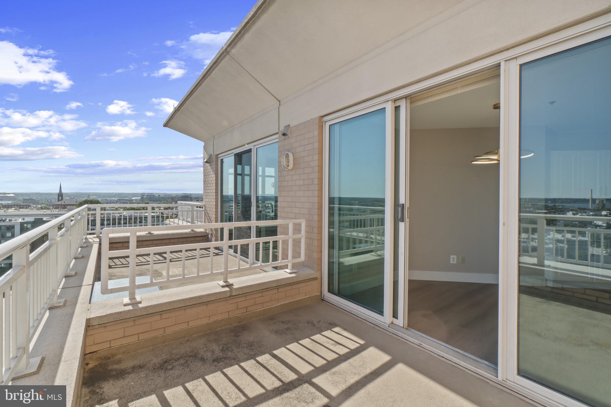 100 Harborview Drive, Unit 1312 Baltimore, MD 21230 - Photo 20 of 37 a view of balcony with floor to ceiling windows and wooden floor