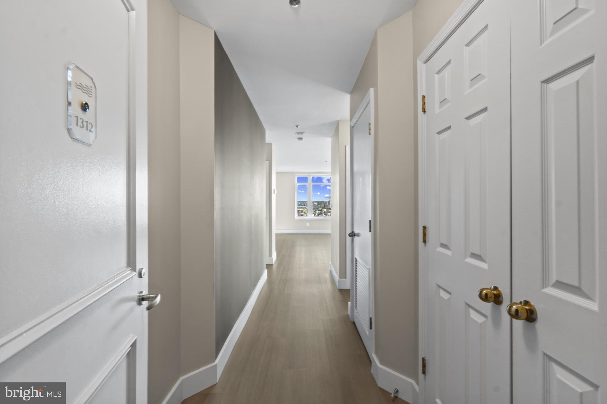 100 Harborview Drive, Unit 1312 Baltimore, MD 21230 - Photo 2 of 37 a view of a hallway with wooden floor and closet