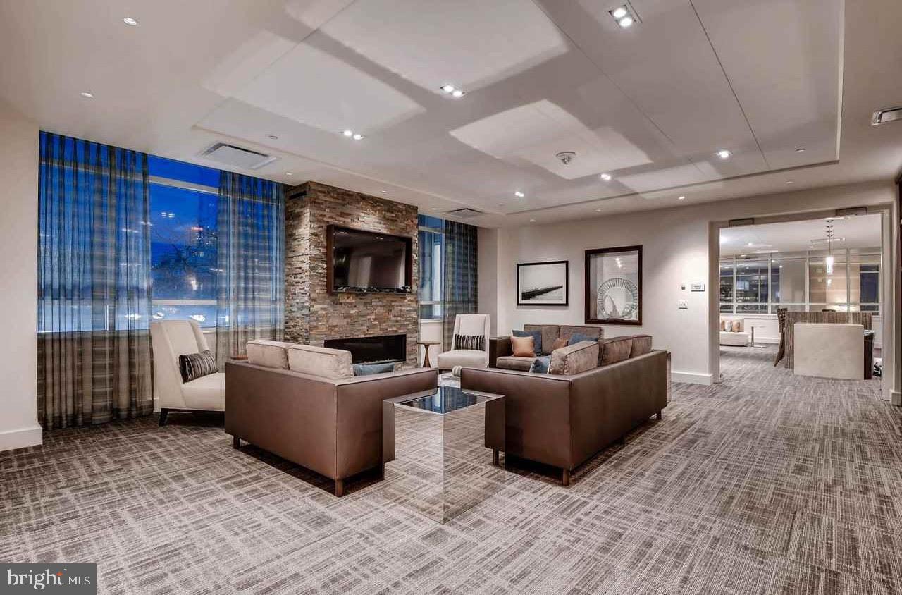 100 Harborview Drive, Unit 1312 Baltimore, MD 21230 - Photo 30 of 37 a living room with furniture and a fireplace