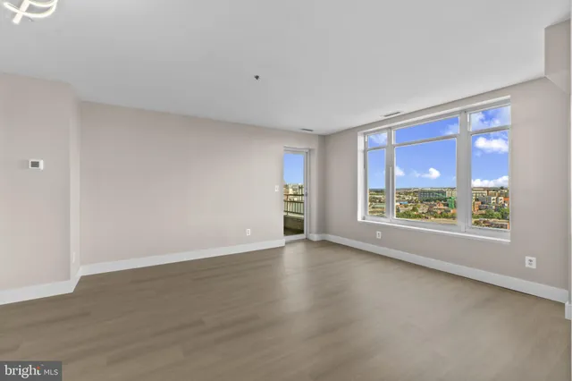 a view of a kitchen with a sink and dishwasher a refrigerator with wooden floor