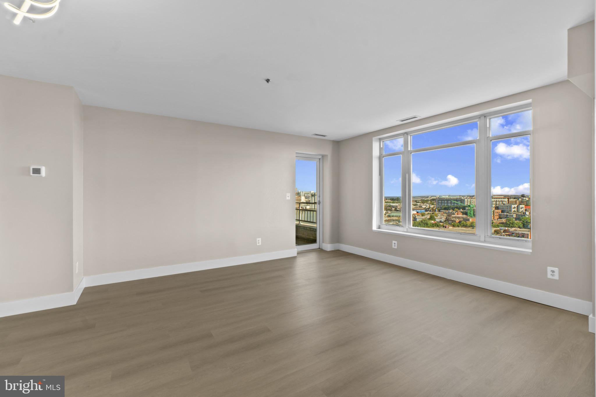 100 Harborview Drive, Unit 1312 Baltimore, MD 21230 - Photo 8 of 37 wooden floor in an empty room with a window