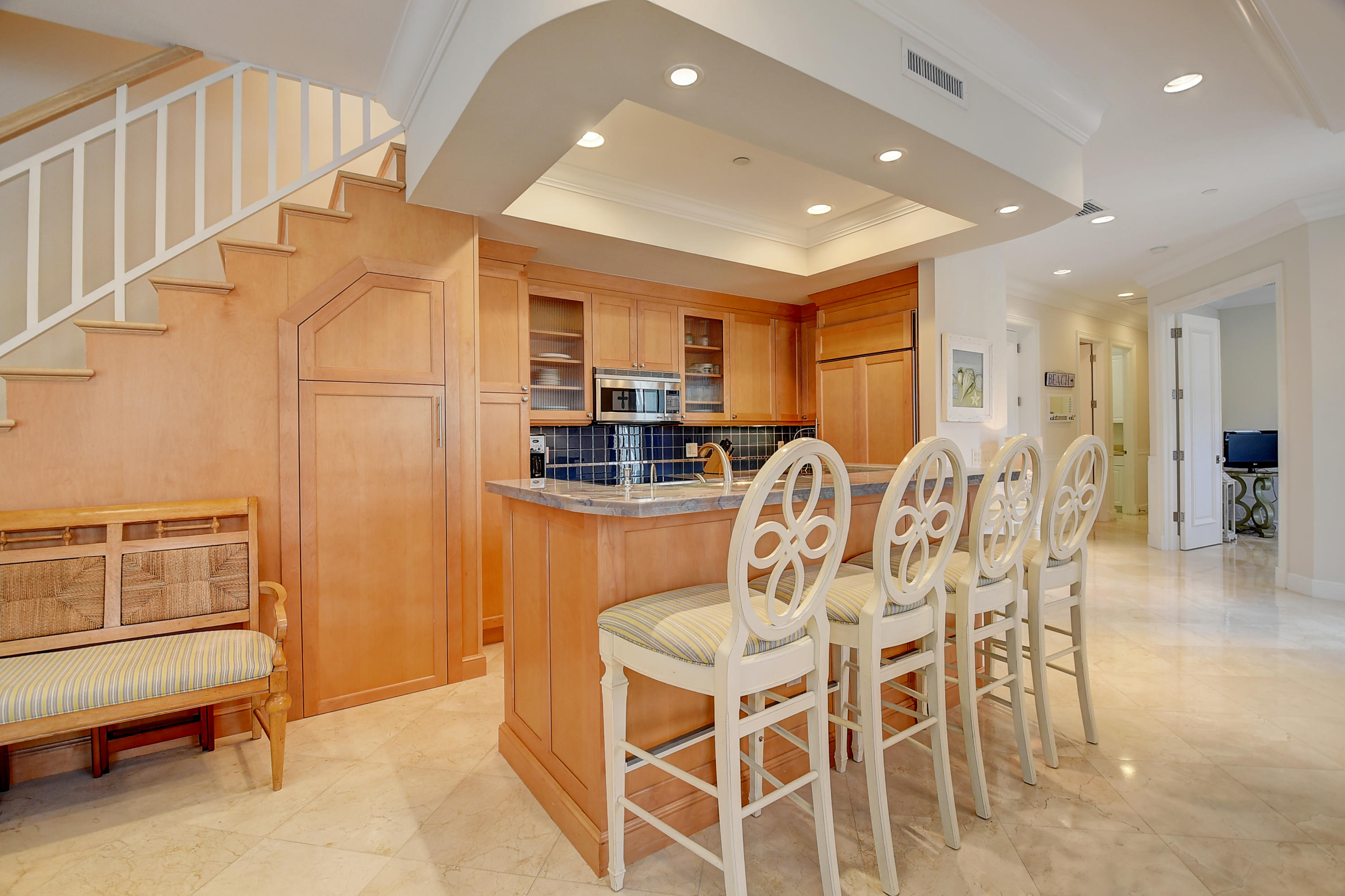 1120 Ocean Terrace Delray Beach, FL 33483 - Photo 15 of 47 a kitchen with stainless steel appliances kitchen island granite countertop a refrigerator and cabinets