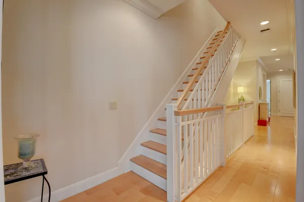 a view of staircase with white walls and a window