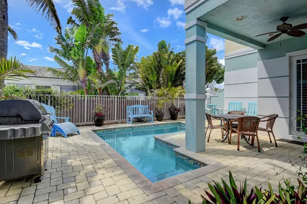 a view of a backyard with sitting area