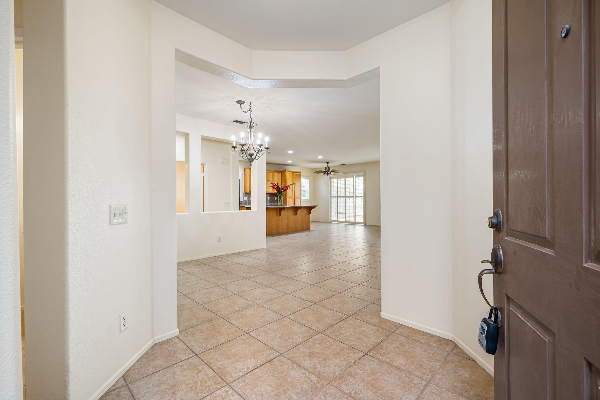 82631 Redford Way Indio, CA 92201 - Photo 11 of 43 a view of a hallway with wooden floor and a kitchen