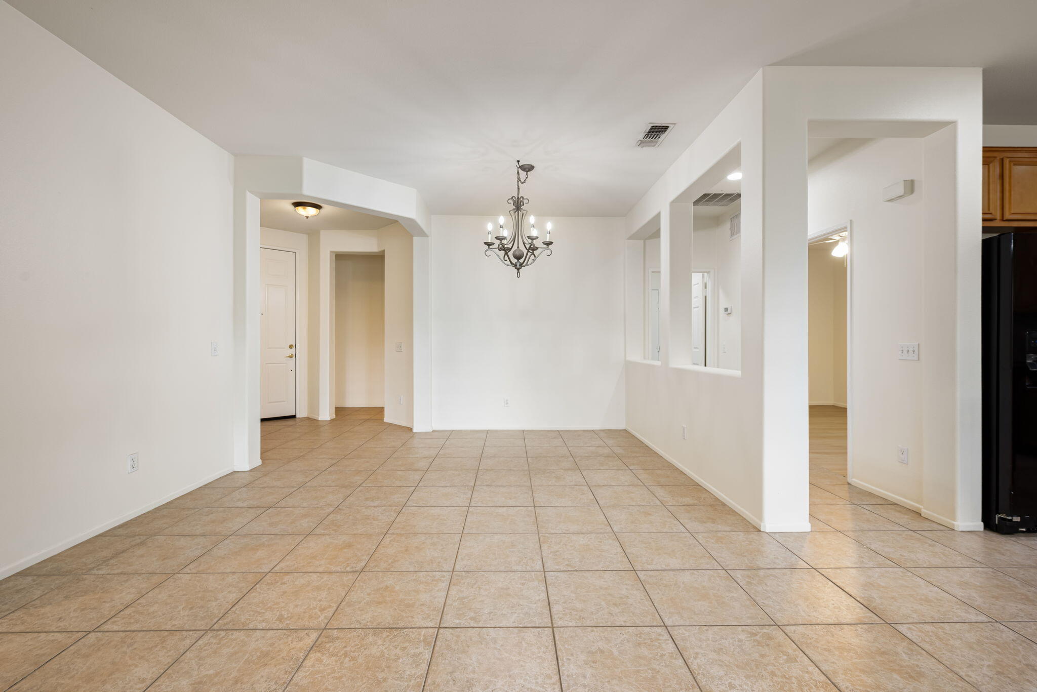 82631 Redford Way Indio, CA 92201 - Photo 13 of 43 wooden floor in an empty room with a chandelier