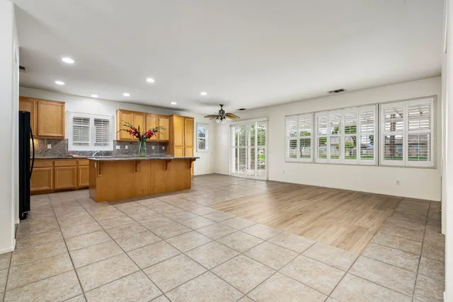 a view of kitchen with stainless steel appliances granite countertop a refrigerator and a sink