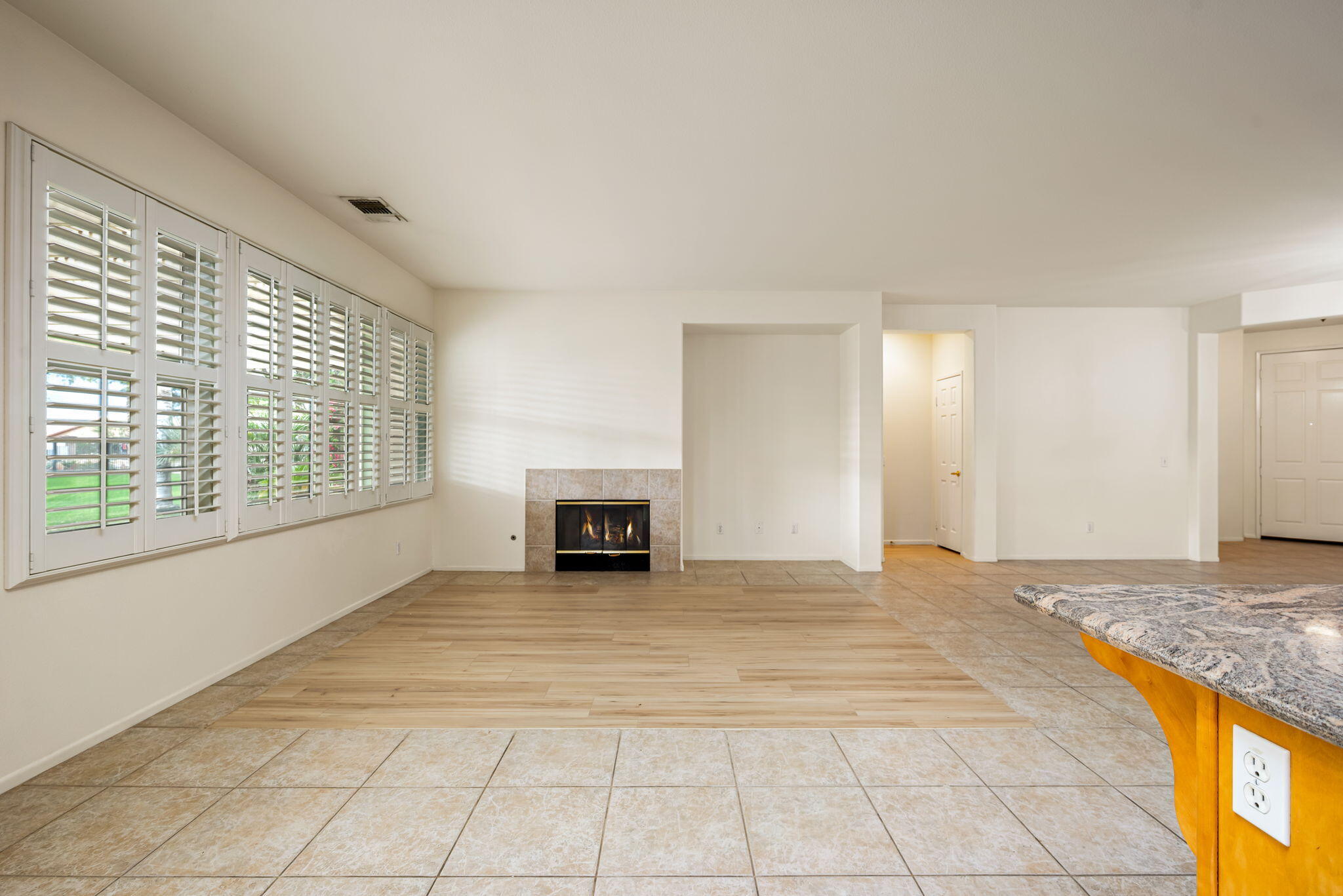 82631 Redford Way Indio, CA 92201 - Photo 17 of 43 a view of an empty room with window and a kitchen