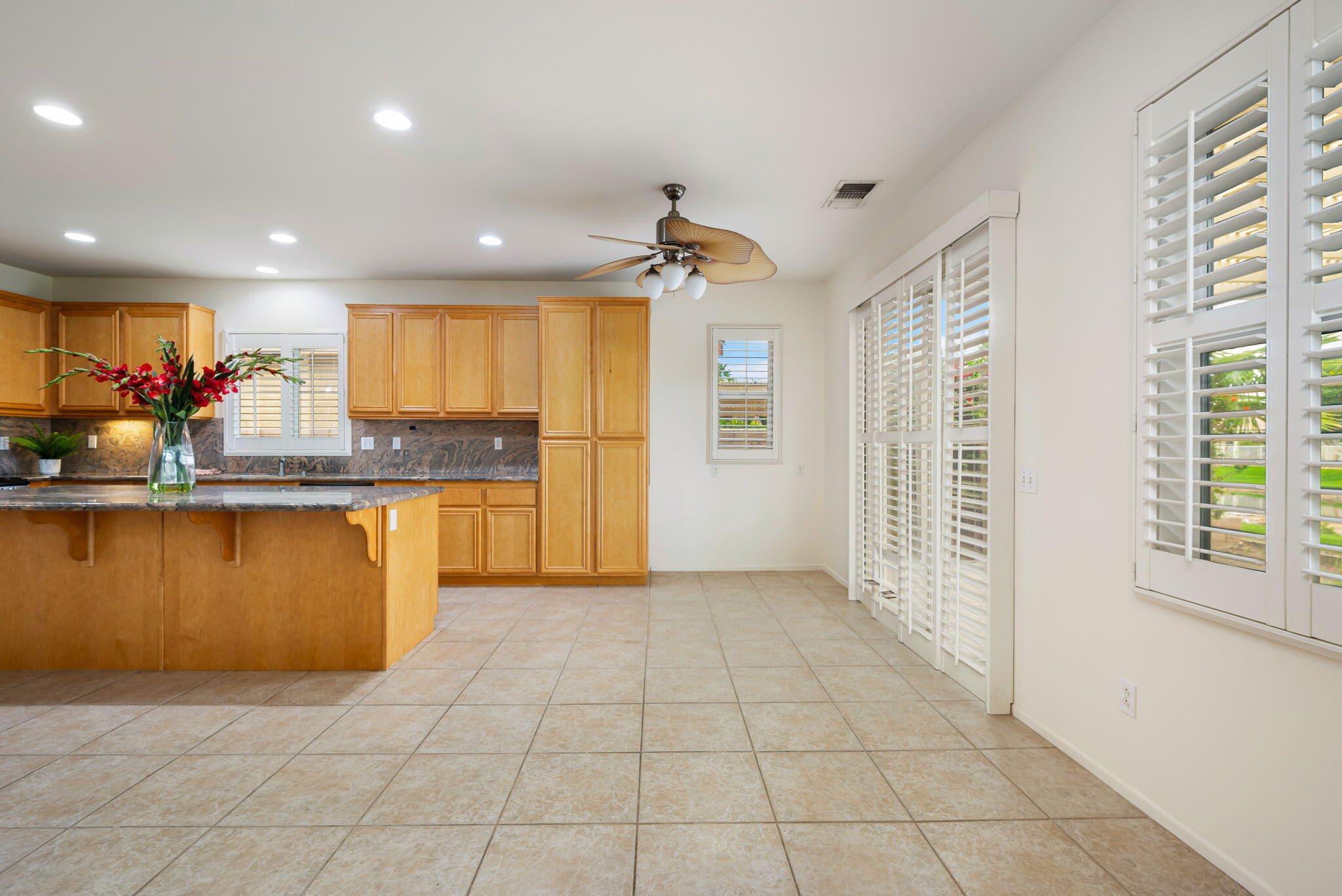 82631 Redford Way Indio, CA 92201 - Photo 19 of 43 a kitchen with granite countertop a refrigerator and a stove top oven