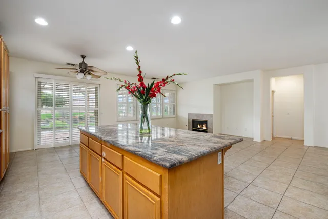a dining hall with granite countertop kitchen island stainless steel appliances a sink and cabinets
