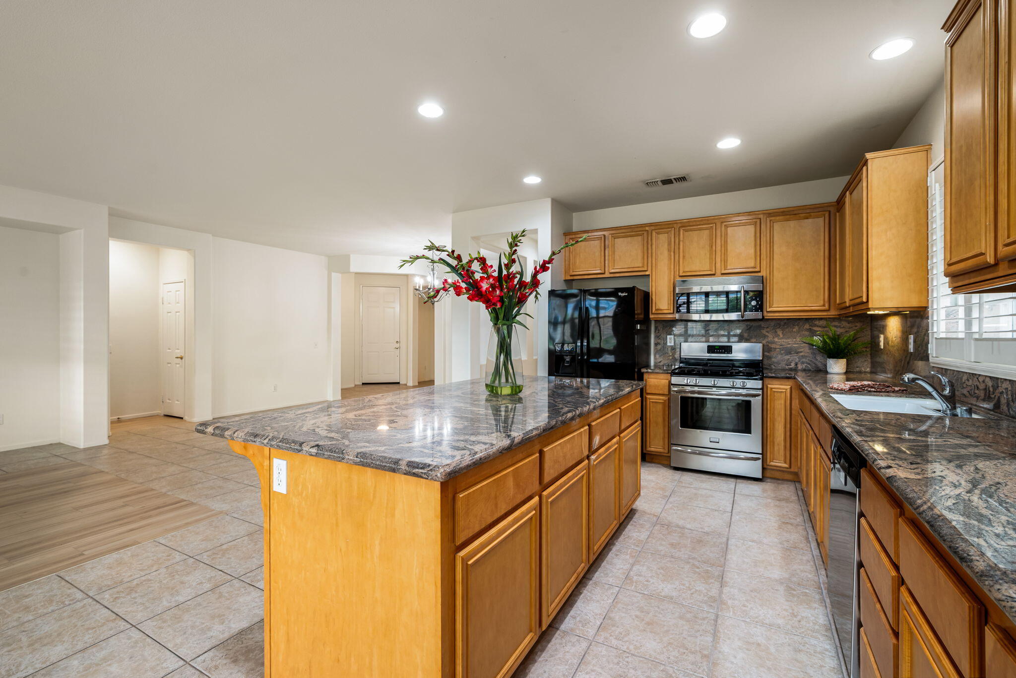 82631 Redford Way Indio, CA 92201 - Photo 24 of 43 a kitchen with stainless steel appliances granite countertop a sink counter space cabinets and a large window