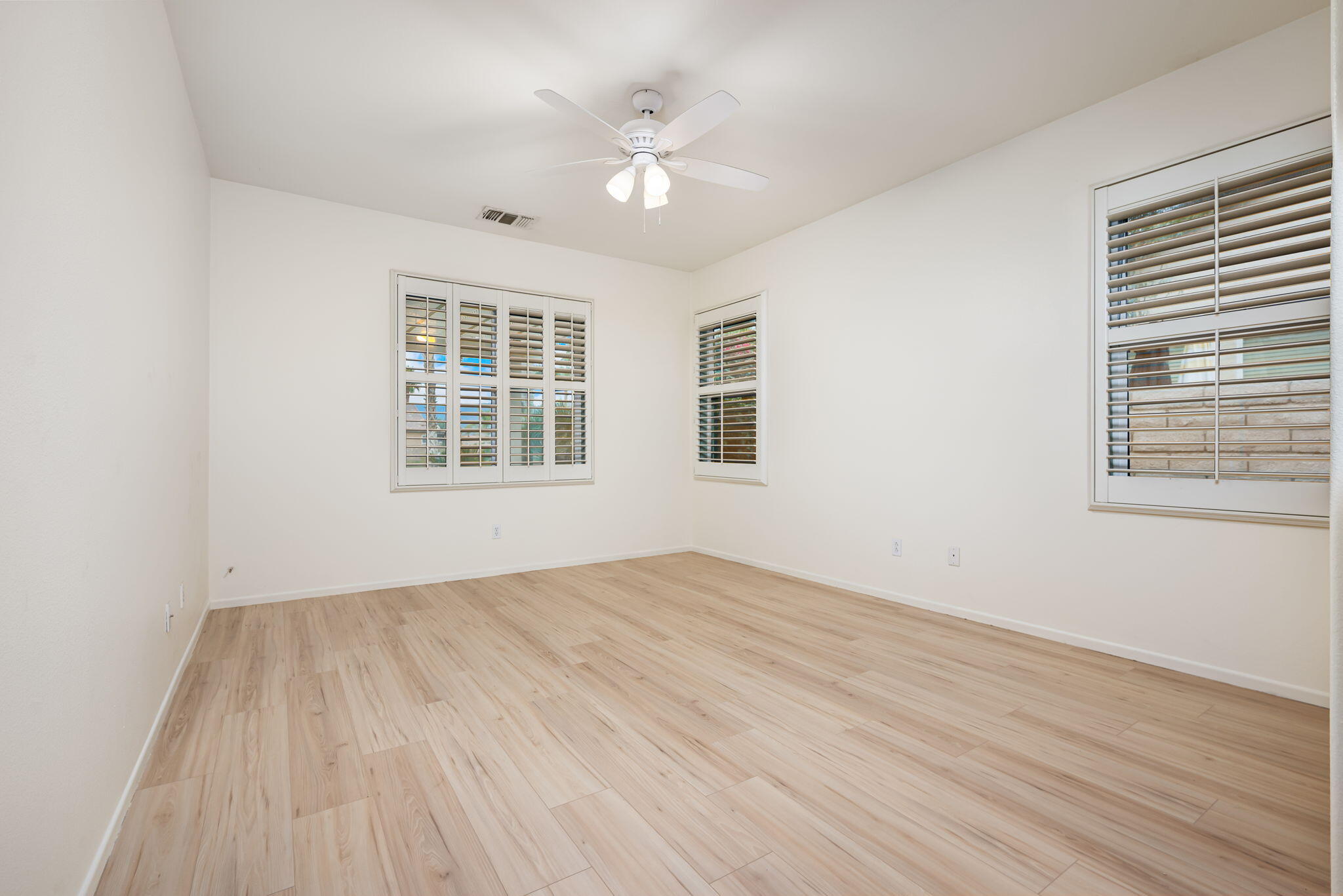 82631 Redford Way Indio, CA 92201 - Photo 26 of 43 a view of empty room with wooden floor and fan