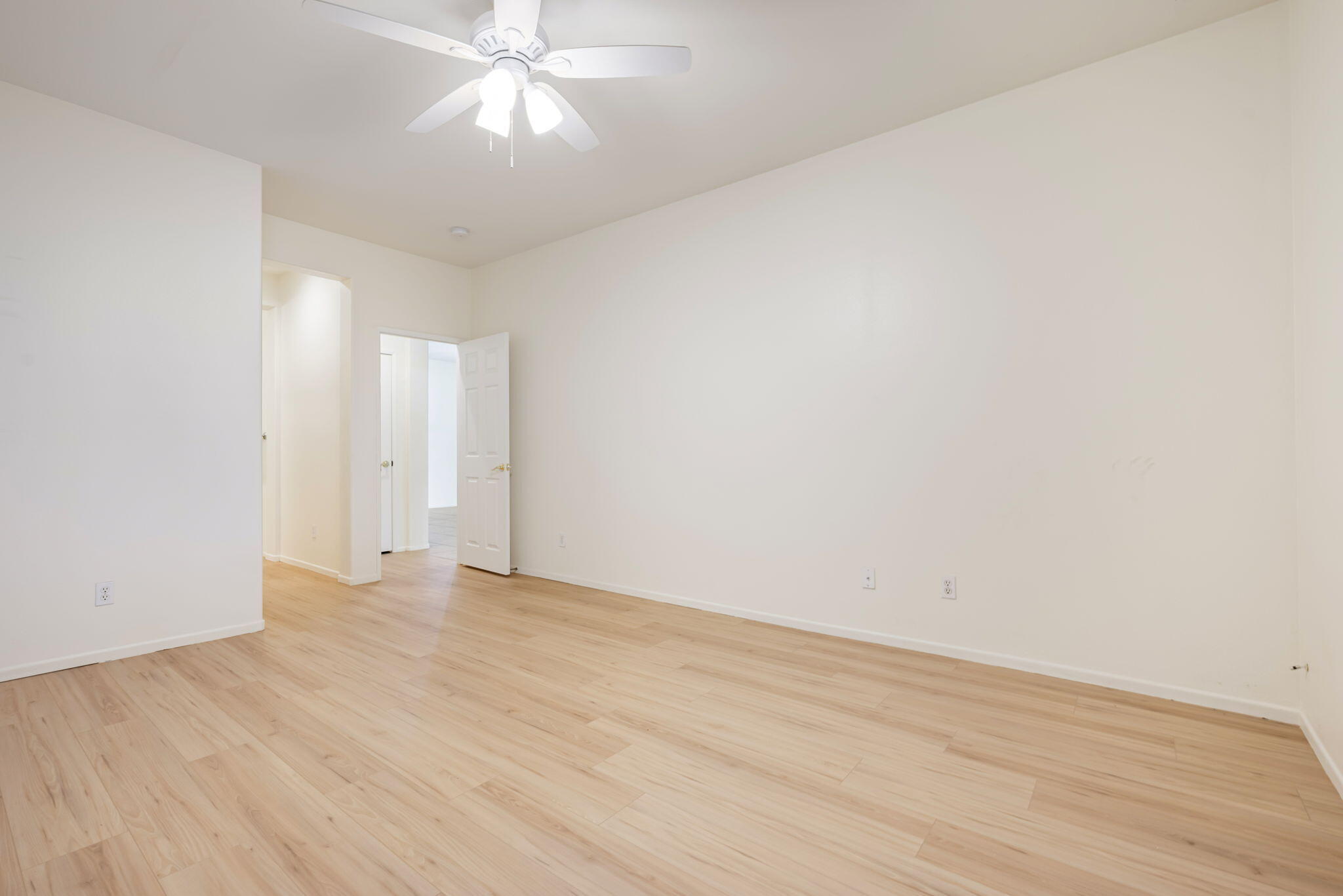 82631 Redford Way Indio, CA 92201 - Photo 27 of 43 a view of an empty room with wooden floor and a ceiling fan