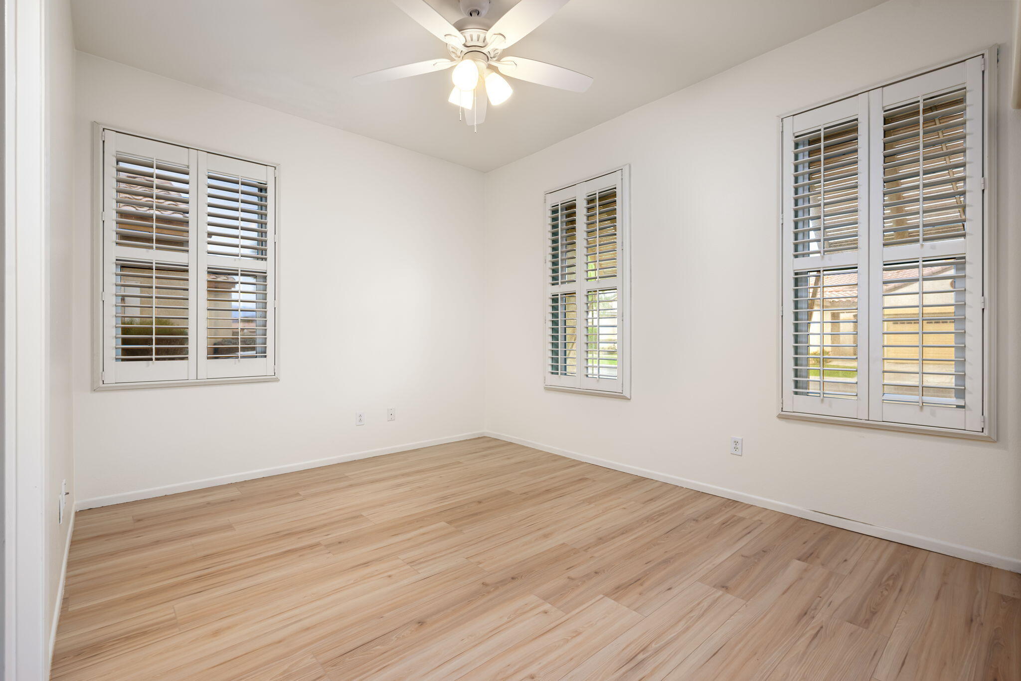 82631 Redford Way Indio, CA 92201 - Photo 33 of 43 a view of empty room with wooden floor and fan