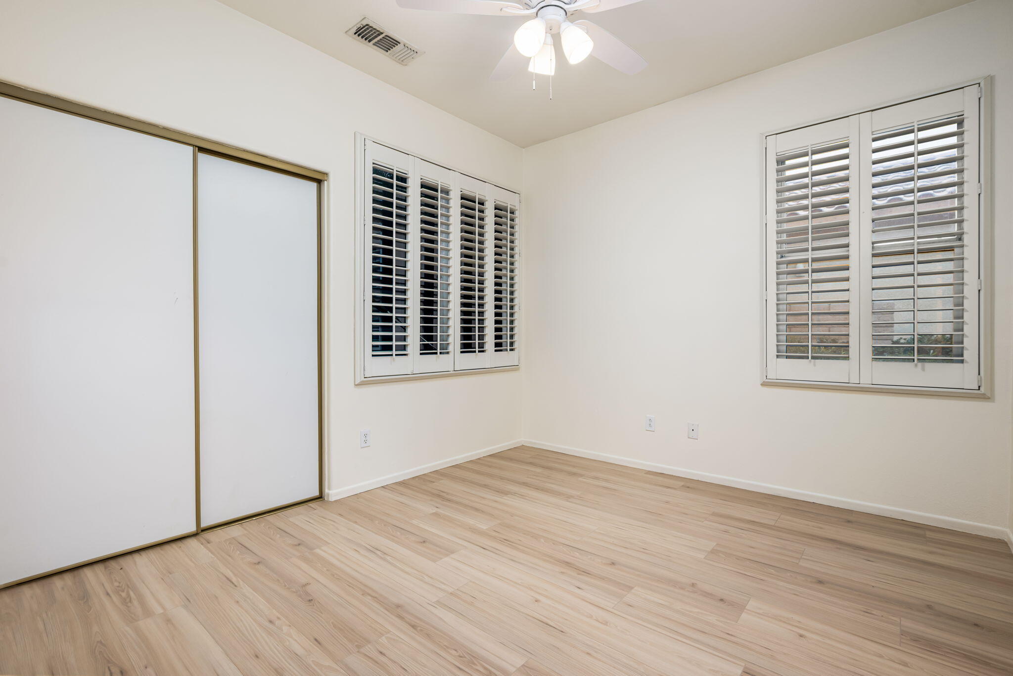 82631 Redford Way Indio, CA 92201 - Photo 37 of 43 a view of empty room with wooden floor and fan