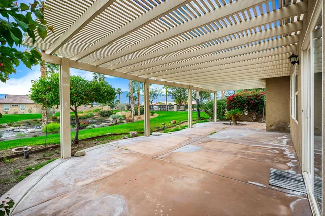 a view of a house with backyard and porch