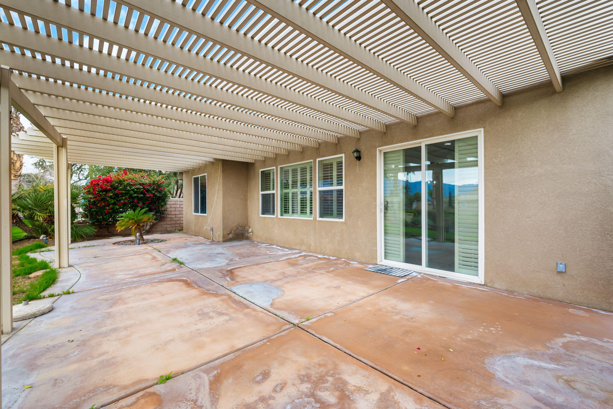 82631 Redford Way Indio, CA 92201 - Photo 40 of 43 a view of an house with backyard porch and garden