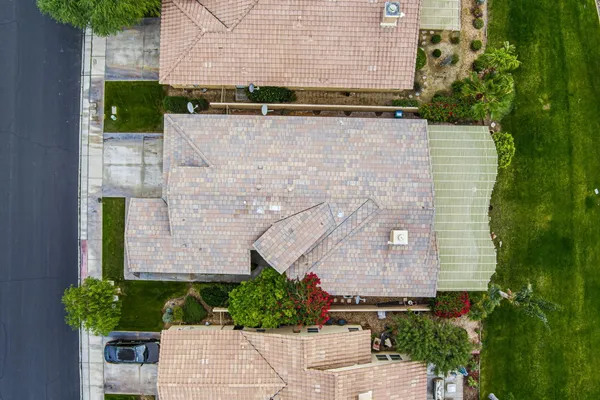 an aerial view of a house with a yard and plants