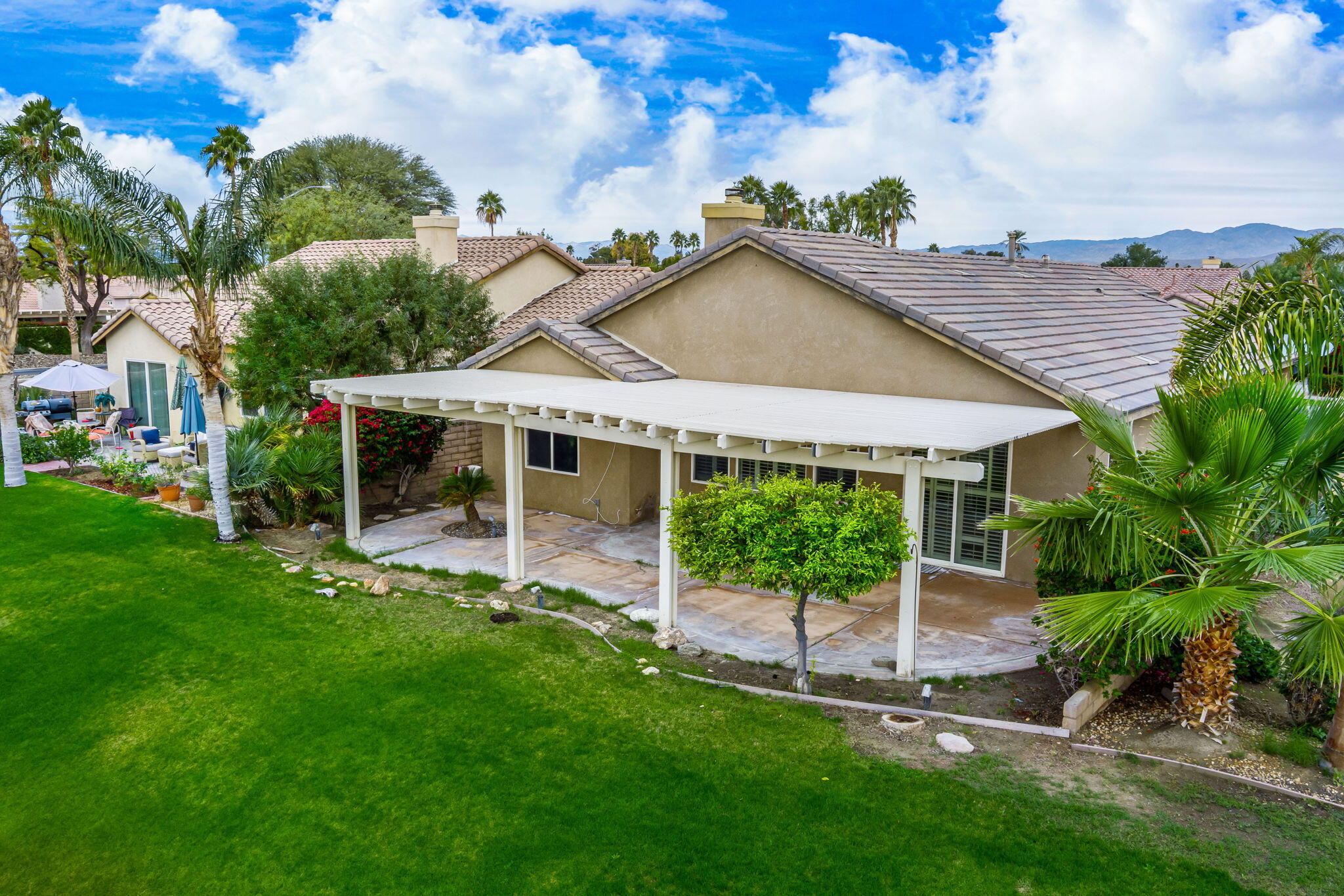 82631 Redford Way Indio, CA 92201 - Photo 8 of 43 a front view of a house with a garden and plants