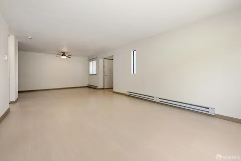 an empty room with a empty space and windows