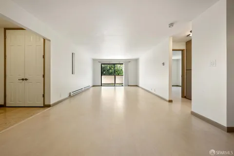 an empty room with windows and closet