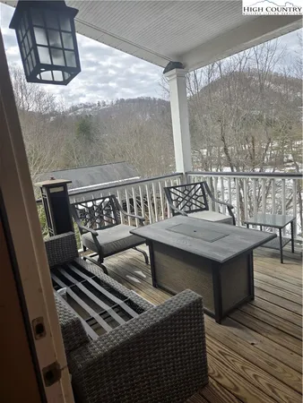a view of a balcony with furniture and wooden floor