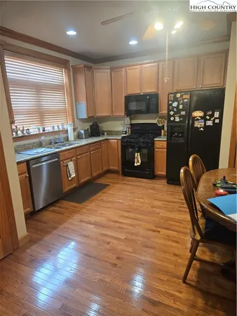 a kitchen with granite countertop stainless steel appliances and wooden cabinets