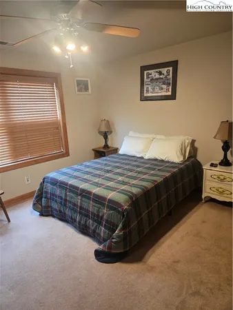 a bed sitting in a room next to a window
