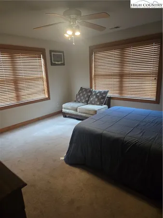 a bedroom with a bed next to a window