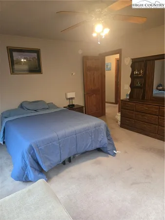 a bedroom with a bed and a night stand