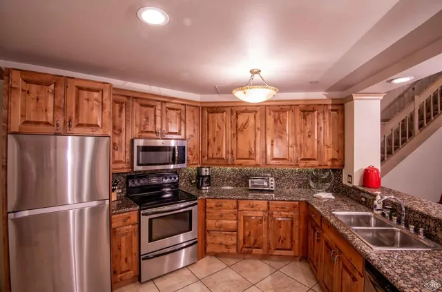 a kitchen with a sink stove and refrigerator