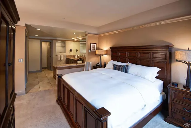 a large white room with a large bed and furniture