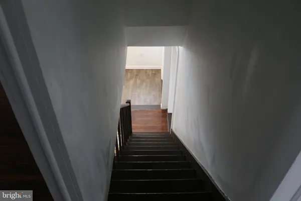 a view of a hallway with wooden floor and entryway